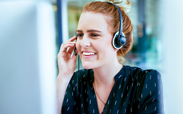 A woman wearing a headset, smiling